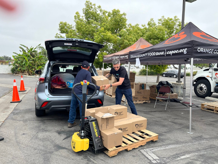 Workers unloading food boxes.